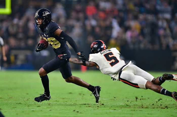 Purdue wide receiver Broc Thompson (29) jukes Oregon State defensive back Alex Austin (5).